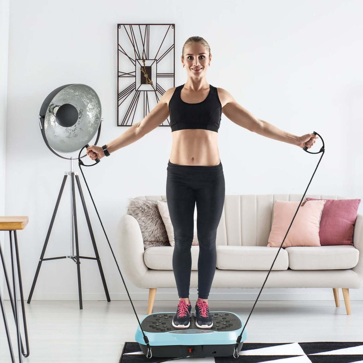 Vibration exercise machine with resistance bands and remote control for full-body workouts at home.